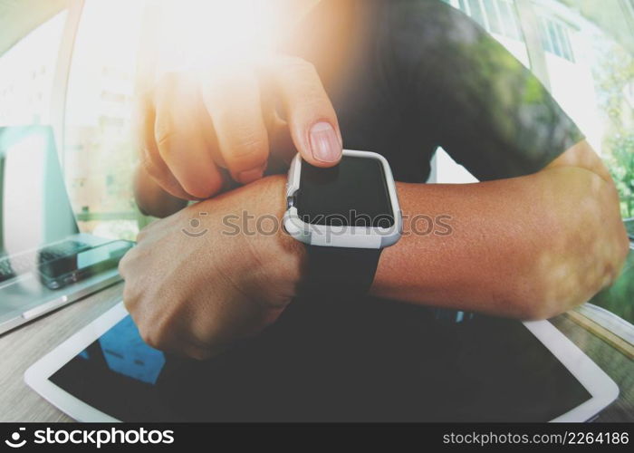 Website designer working with smart watch and digital tablet and digital design diagram on wooden desk as concept