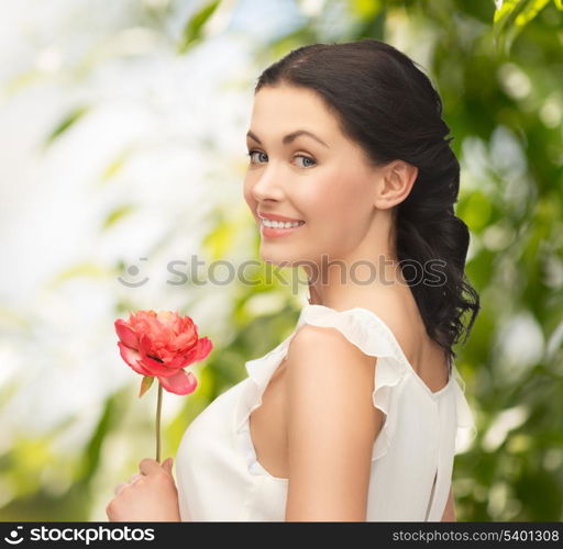 wedding and beauty concept - young woman with flower