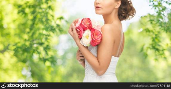 wedding and people concept - beautiful young woman or bride with bouquet of flowers over green natural background. young woman or bride with bouquet of flowers
