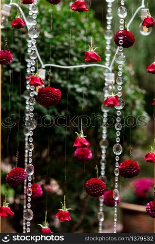 Wedding arch decoration close-up. red roses, aster flowers and crystals. Vertical. selective focus.. Wedding arch decoration close-up. red roses, aster flowers and crystals. Vertical. selective focus