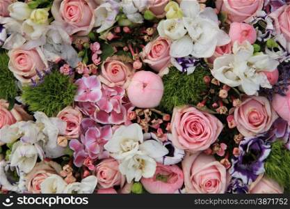 Wedding arrangement in various shades of pink and different sorts of flowers