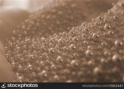 Wedding background. Close-up of pearls bridal dress details, powdery colo, tenderness. Wedding background. Close-up of pearls bridal dress details, powdery color, tenderness.
