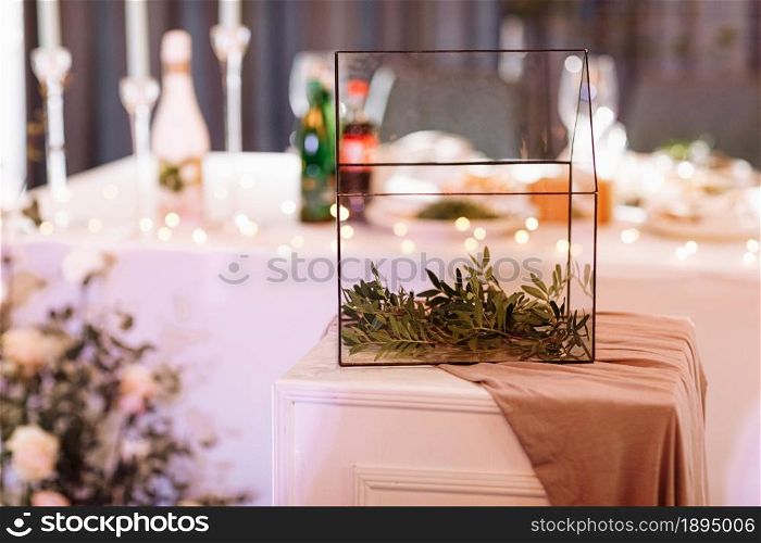 Wedding. Banquet. The festive table for guests, decorated with a composition of white and pink flowers and greenery, there are candles, served with crockery in restorane.. Wedding. Banquet. The festive table for guests, decorated with a composition of white and pink flowers and greenery, there are candles, served with crockery in restorane