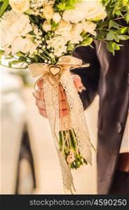 wedding bouquet in hands of the groom, decor heart