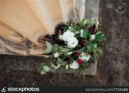 wedding bouquet of red flowers and greenery