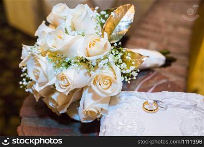 Wedding bouquet of roses with two rings on a pillow. Wedding bouquet of roses with two rings