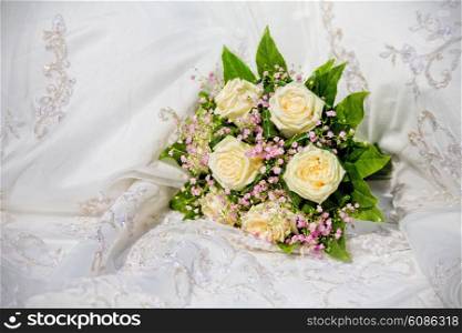 wedding bouquet on wedding dress background