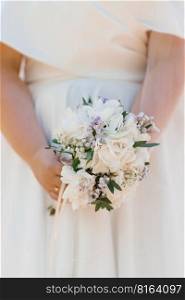 Wedding bouquet with white hydrangea in the hands of the bride
