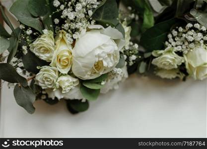 wedding bouquets of white roses and greens for bridesmaids on a white table. brides morning. wedding accessories. selective focus.. wedding bouquets of white roses and greens for bridesmaids on a white table. brides morning. wedding accessories. selective focus