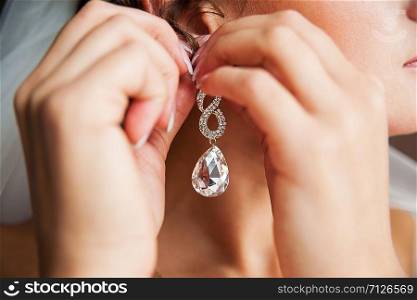Wedding bride hangs Gold earrings with diamond.. Wedding bride hangs Gold earrings with diamond