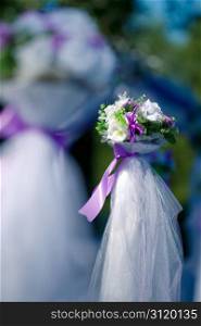 Wedding bunch of flowers decorated with purple ribbons and white organza