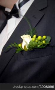 wedding buttonhole with rose on mans suite