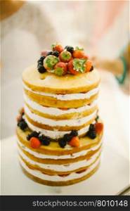 wedding cake decorated with berries and strawberries