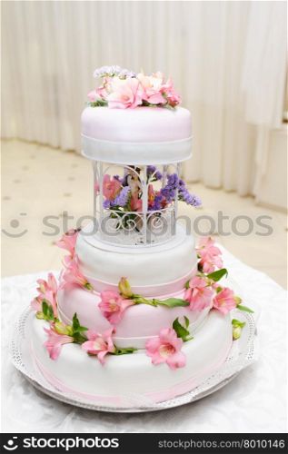 Wedding Cake decorated with pink lily flowers