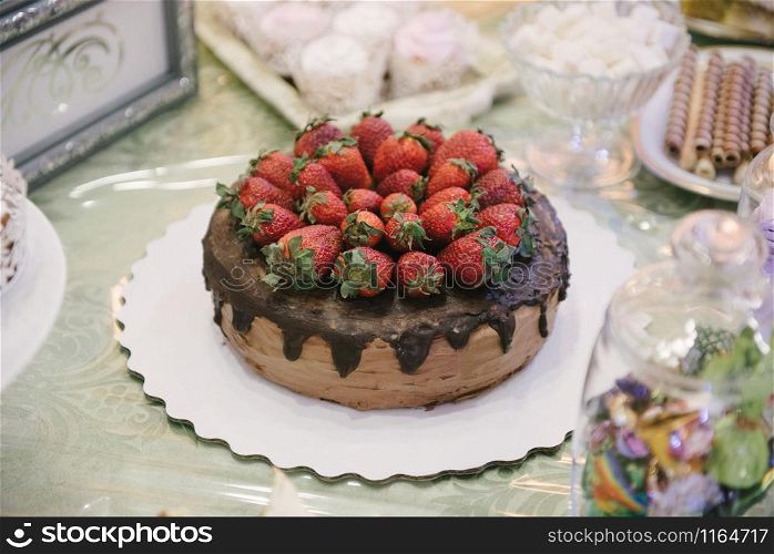wedding cake with strawberries close-up. wedding cake with strawberries close-up on a wedding table