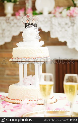Wedding cake with two grooms on top, for gay marriage ceremony.