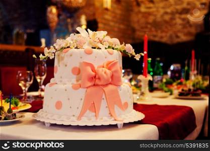 Wedding cake with white icing and pink bow
