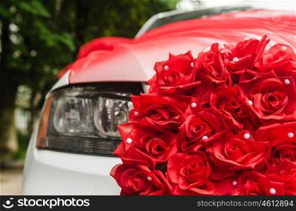 wedding car decorated with red roses