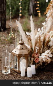 wedding ceremony area with dried flowers in a meadow in a pine brown forest