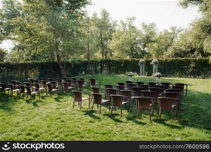 wedding ceremony in the woods among the trees on the green track