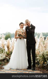 wedding ceremony on a high pier near the river with invited guests