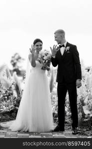 wedding ceremony on a high pier near the river with invited guests