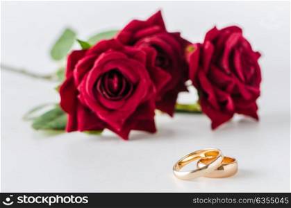 Wedding concept with rings and roses. The wedding concept with rings and roses