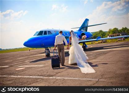 Wedding couple are prepare to fly on a honeymoon trip