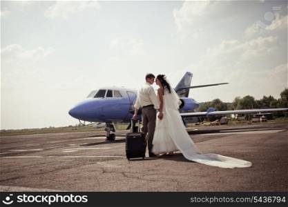 Wedding couple are prepare to fly on a honeymoon trip