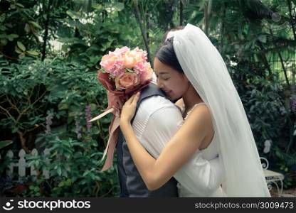 Wedding couple, groom and bride, beautiful woman and man, hug each other and hold bouquet flower, love and valentine concept