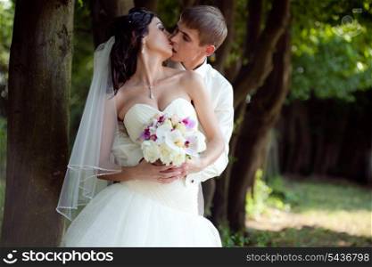 Wedding couple kissing outdoor