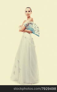 Wedding day. Full length young attractive romantic bride in white dress with blue fan instagram filter