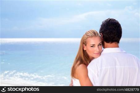 Wedding day on seashore, young family on the beach celebrating marriage, wife looking through husband shoulder, summer traveling, love concept