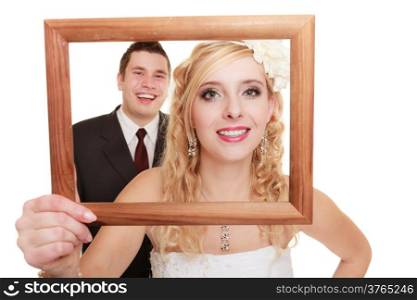 Wedding day. Portrait of happy bride woman girl and groom man couple in wooden frame isolated on white. Studio shot.