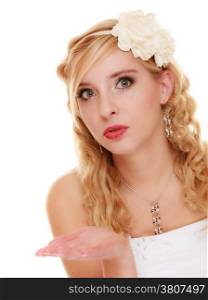 Wedding day. Portrait of young blond woman romantic attractive bride blowing a kiss or showing blank copy space on empty hand isolated on white. Studio shot.