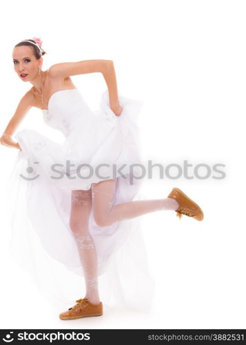 Wedding day. Running bride funny young woman wearing sport shoes isolated on white background