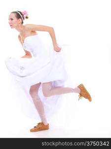 Wedding day. Running bride funny young woman wearing sporting shoes isolated on white background