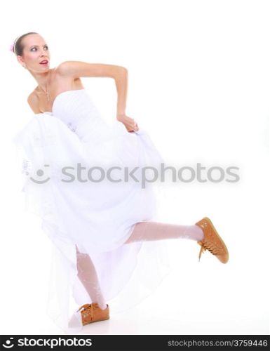 Wedding day. Running bride funny young woman wearing sporting shoes isolated on white background