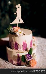 wedding decor with cake on a wooden bench against a waterfall background