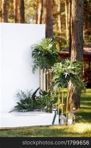 Wedding decorations in luxury ceremony. Arch for wedding ceremony a is decorated with flowers and greens, greenery. wedding decor outdoors in the forest on summer sunny day. Wedding decorations in luxury ceremony. Arch for wedding ceremony a is decorated with flowers and greens, greenery. wedding decor outdoors in the forest on summer sunny day.