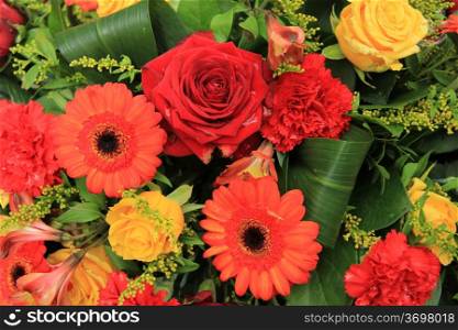 Wedding decorations in red, orange and yellow: gerberas, carnations and roses