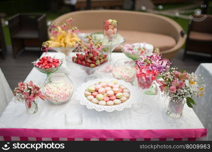 wedding dessert with delicious cakes and macaroons