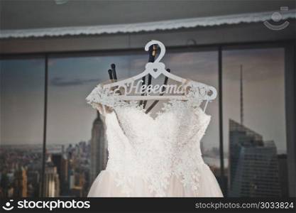 Wedding dress on a hanger.. Bridesmaid dress at themed hanger 1192.. Bridesmaid dress at themed hanger 1192.