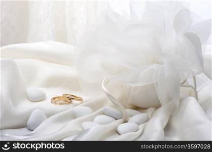 wedding favors and wedding ring on white background