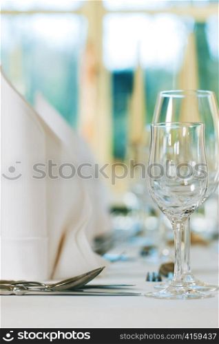 Wedding - feastfully decorated table with silverware and glasses