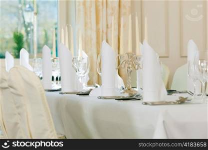 Wedding - feastfully decorated table with silverware and glasses