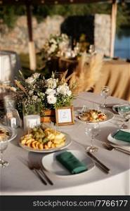 wedding festive banquet outdoors near the water