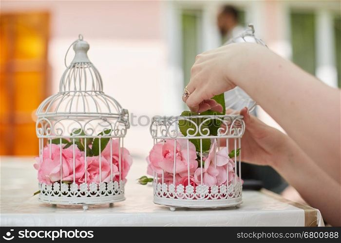Wedding floral decoration in beautiful vintage birdcage. Wedding decor idea