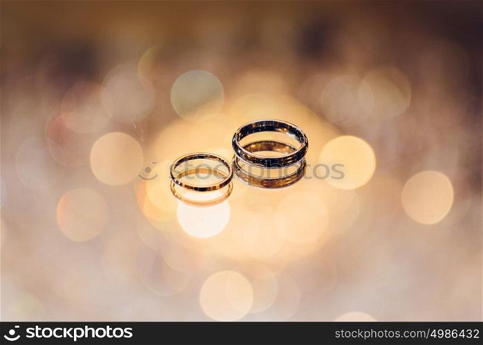 Wedding golden rings of bride and groom. Wedding ceremony concept.