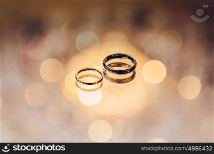 Wedding golden rings of bride and groom. Wedding ceremony concept.